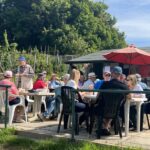 People seated enjoying cream tea at Chesham alotments